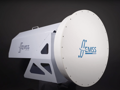 A digital model of the Band 2 feed. The component has a white structure with on the right side a circular drum-like part with the EMSS Antennas logo. 