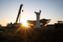 Dawn over the SKA-Mid site, with the pedestal and the main reflector on the ground, with a crane to the left